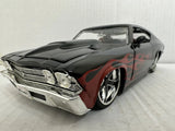 Black 1969-style Chevelle SS die-cast model car with red flame graphics, 1:24 scale.