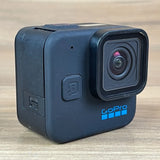 GoPro mini action camera with front lens and side ports, dark blue for parts