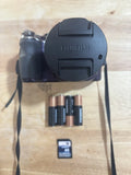 Fujifilm FinePix S4530 digital camera with lens cap, batteries, and SD card