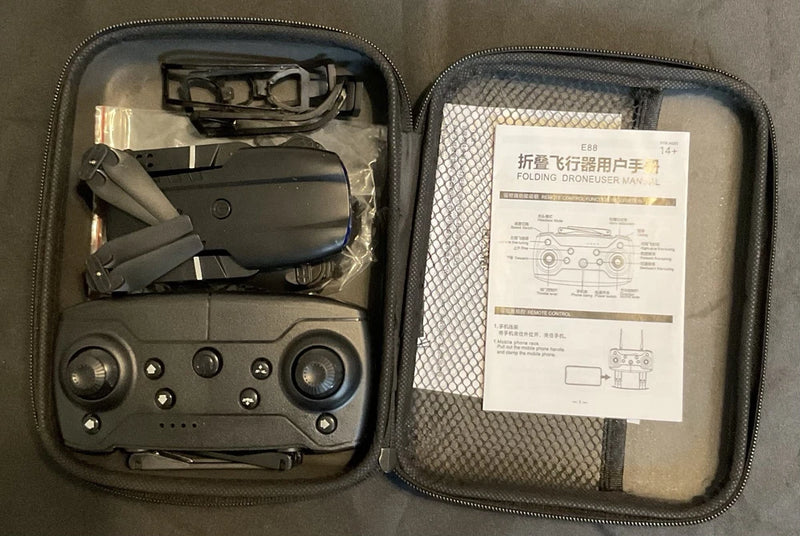 Folding drone with controller and propeller arms in zippered hard case