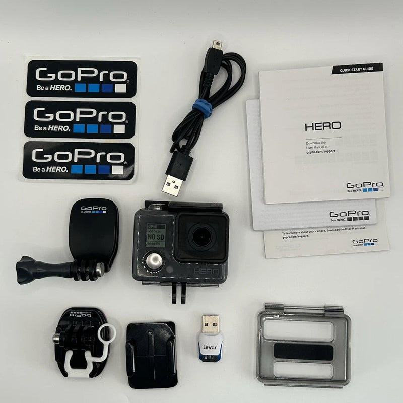 Pre-owned GoPro Hero action camera with housing, mounts, cables, case, and manuals