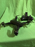 Foldable black quadcopter drone with camera, four propellers and extended landing gear