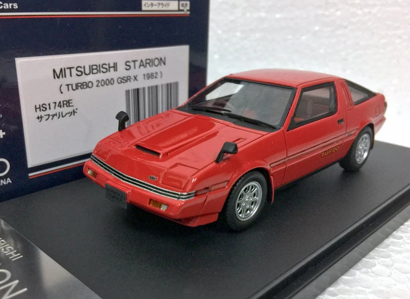 Red 1982 Mitsubishi Starion turbo model car with hood vents, 3/4 front view on black base
