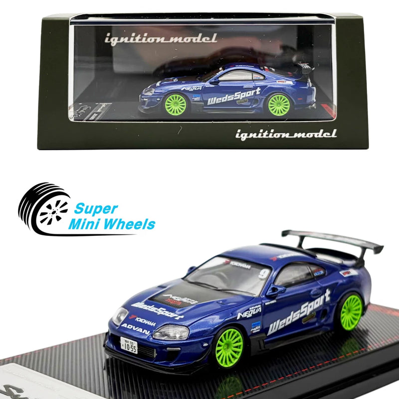 Blue Toyota Supra die-cast model car with green wheels, shown in display packaging.