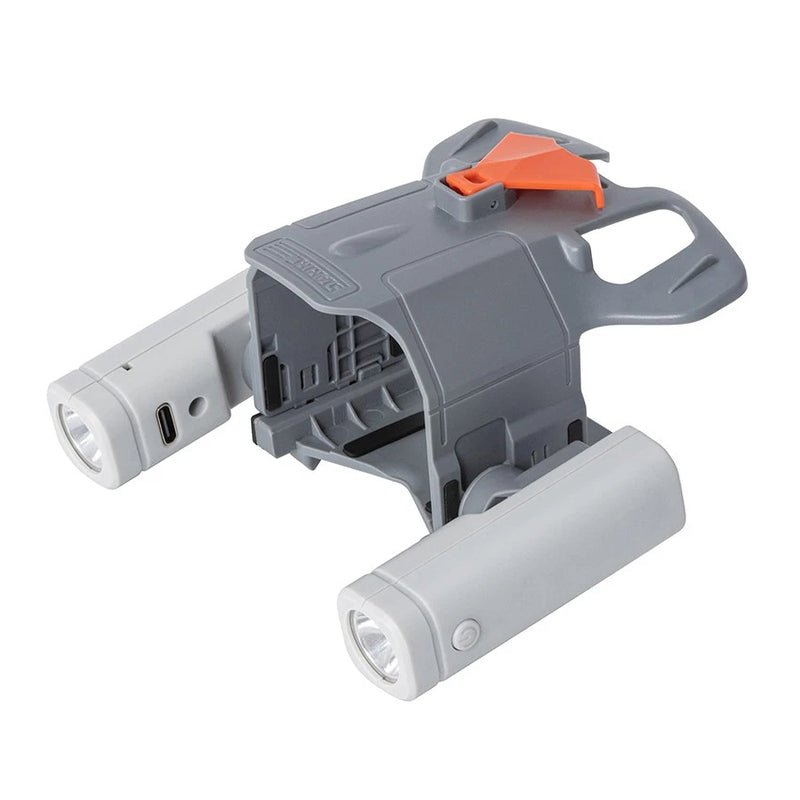 Gray drone searchlight accessory with orange switch and dual white spotlights