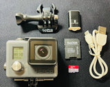 GoPro Hero+ action camera in clear waterproof case with lens, mount, SD cards, and USB cables