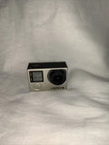 GoPro HERO4 action camera with front lens, screen, and SD card slot on silver body
