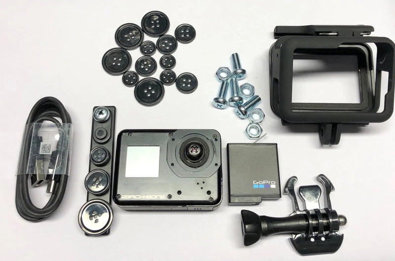 Black action camera housing kit with lens module, mount handle, and screws