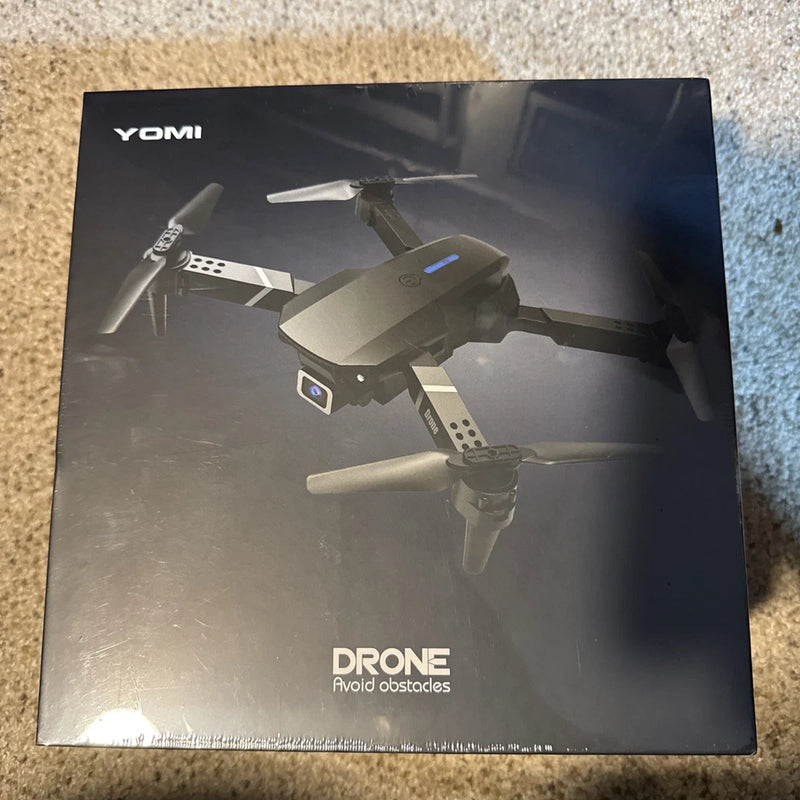 Foldable YOMI quadcopter drone box with front view illustration