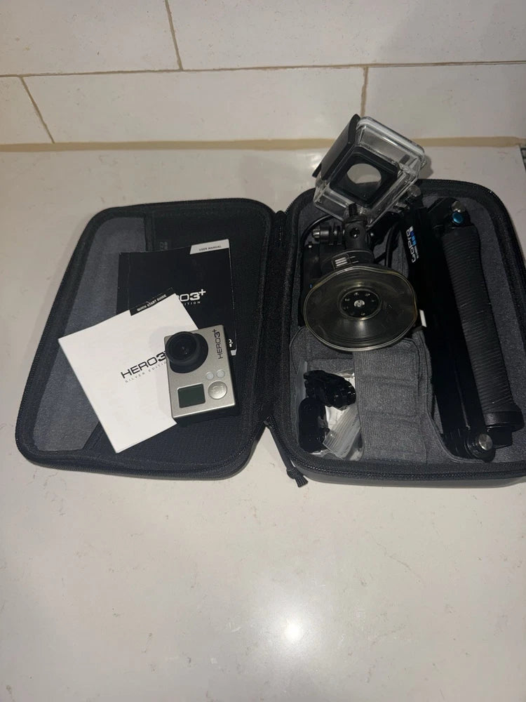 GoPro HERO3 action camera kit in open black case with camera, housing, and accessories