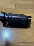 Panasonic X980M (Brown) with 990 hood, shoe adapter, and separate charger.