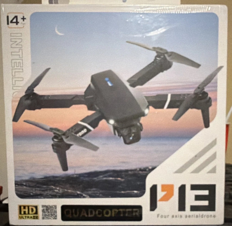 Black quadcopter drone with four propellers and HD camera, shown on product box