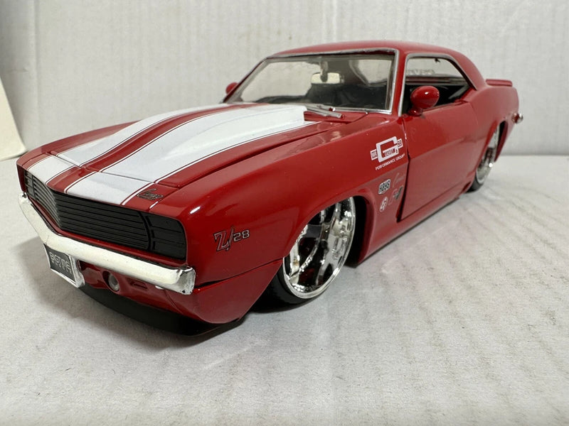 JADA Bigtime die-cast 1:24 Chevy Camaro Z28 model car, red with white stripes, front angle