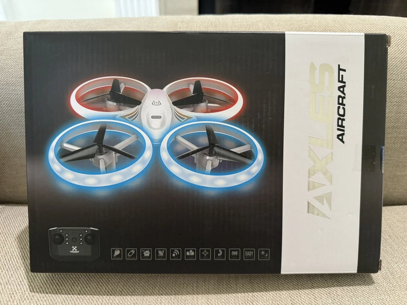 Mini quadcopter drone with four propellers and multicolor LED ring lights