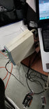 Beige audio interface with connected cables and front panel ports