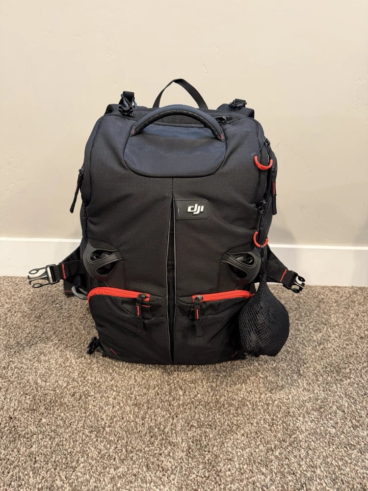 Black DJI drone travel case backpack with red zipper accents and carry handle