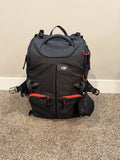 Black DJI drone travel case backpack with red zipper accents and carry handle