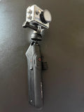 Black action camera on handheld gimbal stabilizer with buttons and front lens