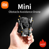 Mini quadcopter drone with camera, black body and orange prop guards