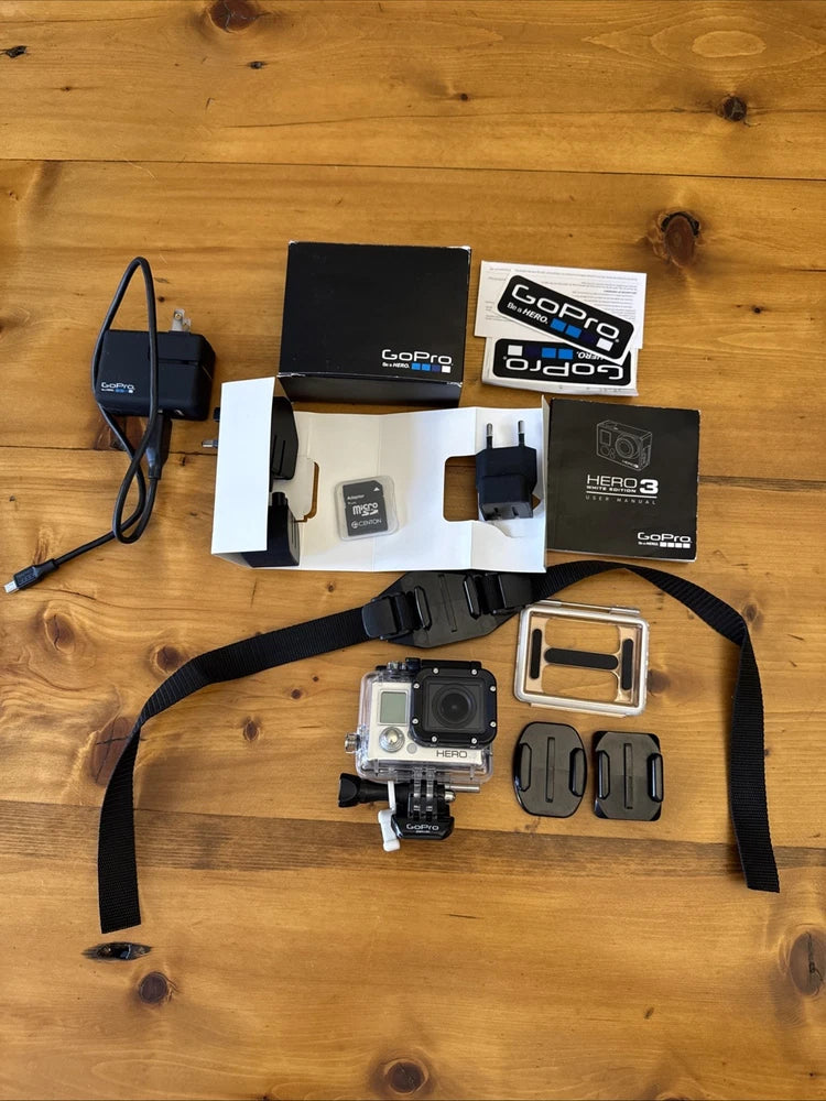 GoPro action camera kit with white camera, black waterproof housing, mounts and straps