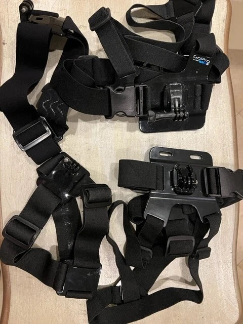 GoPro action camera mounting harness with black straps and case mounts