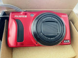 Red FUJIFILM FinePix digital camera with black lens and hand grip details