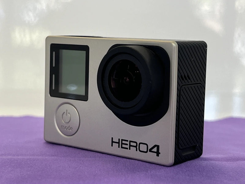 Silver action camera with front screen and lens, HERO4 logo on side