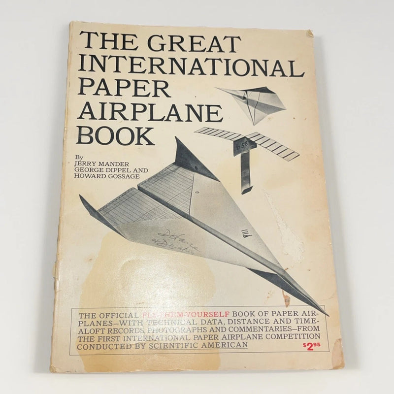 Vintage paper airplane instruction book with illustrated cover and bold title