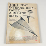 Vintage paper airplane instruction book with illustrated cover and bold title
