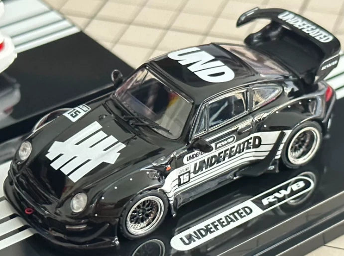 Black 1/64 model car with UNDEFEATED decals and RWB 911 styling