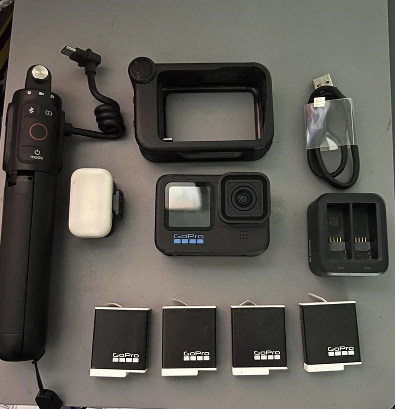 Black action camera with waterproof case, media mod, and Enduro batteries with charger
