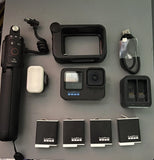 Black action camera with waterproof case, media mod, and Enduro batteries with charger