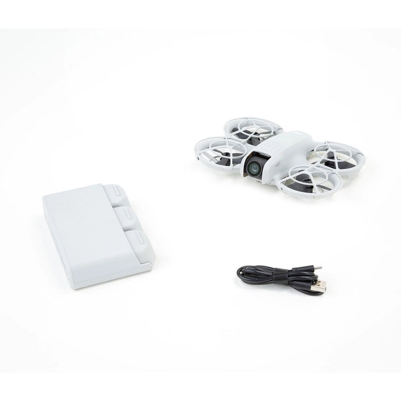 DJI Neo drone kit: white quadcopter with propellers, battery pack, USB charging cable