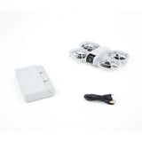 DJI Neo drone kit: white quadcopter with propellers, battery pack, USB charging cable