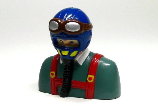 Toy pilot bust figurine with blue helmet, green suit, and red life vest