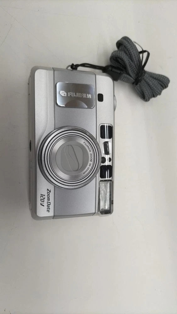 Silver Fujifilm film camera with built-in lens and date display, front view with strap
