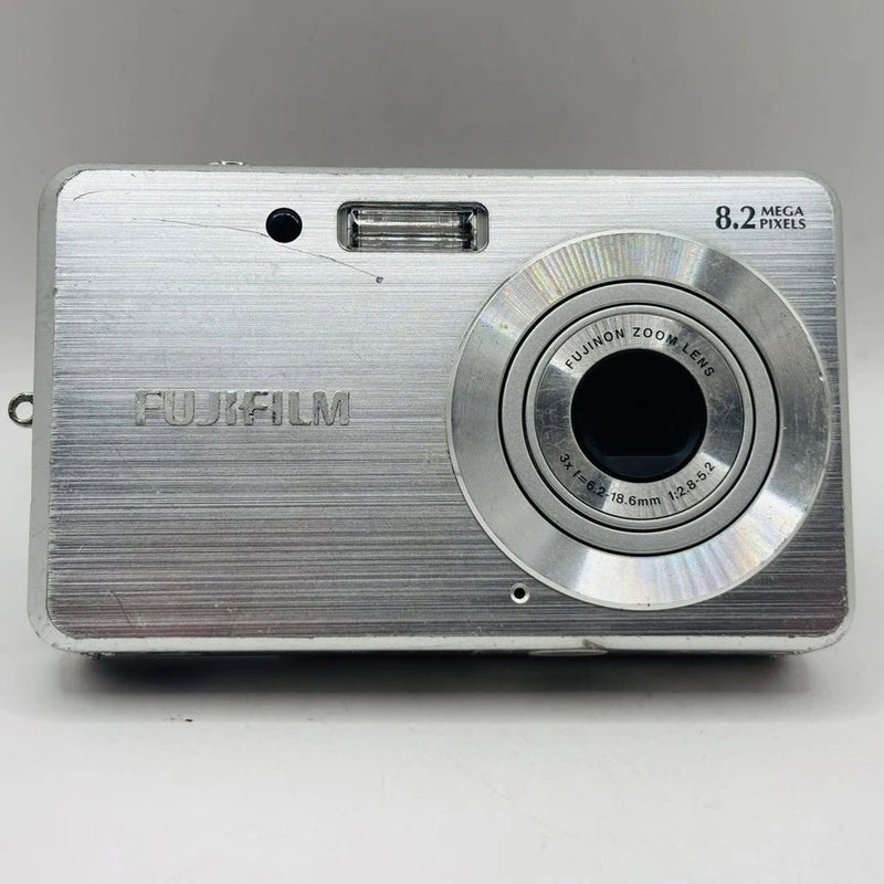 Silver FUJIFILM FinePix J10 compact digital camera front with zoom lens and flash
