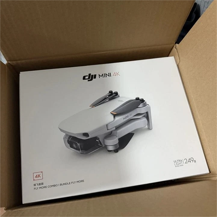 DJI Mini 4K gray aerial drone in retail box, ready for remote control