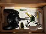 Drone and black remote controller with folded propellers, packed in a box
