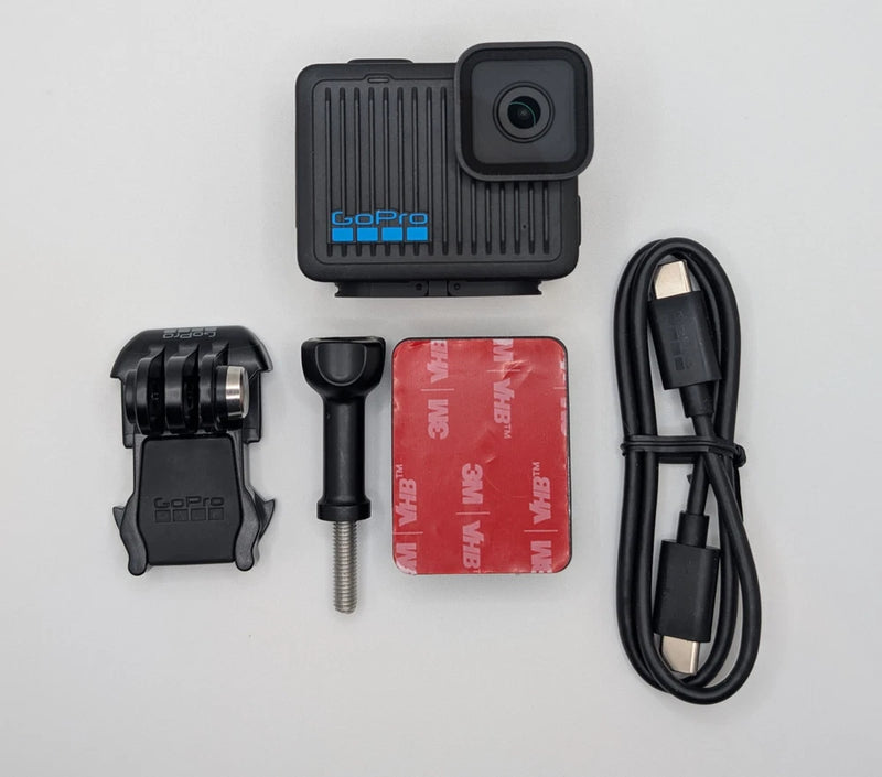 GoPro HERO action camera with mount, red battery, and USB cable
