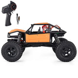 1:18 orange RC rock crawler car with black chassis, large tires and handheld controller