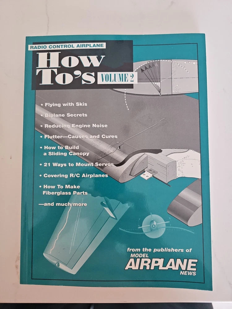 Radio control airplane how-to book with teal cover: 'How To's Volume 2'.