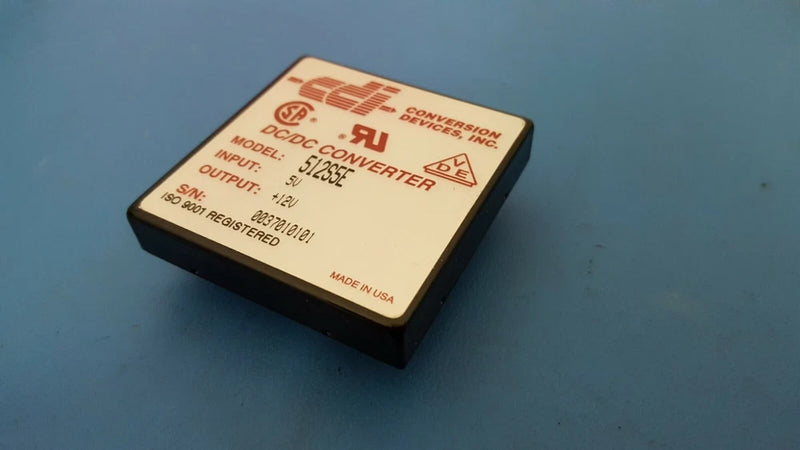 DC-DC converter module with beige top label and black casing