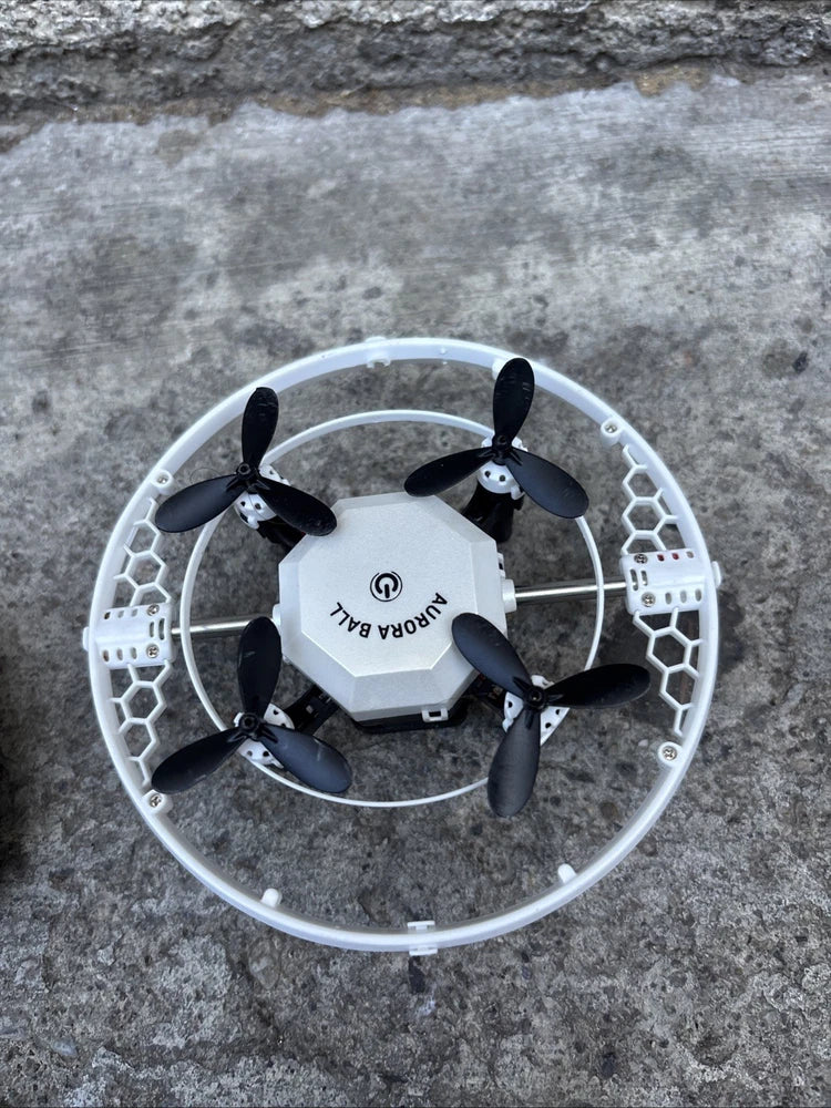 Mini quadcopter drone with white body, black propellers, and protective circular guard