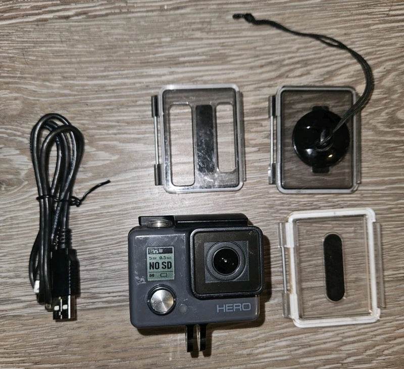 GoPro HERO action camera with waterproof housing, lens front and USB charging cord