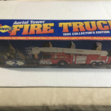 Battery-operated aerial tower fire truck model in box with red truck and ladder artwork