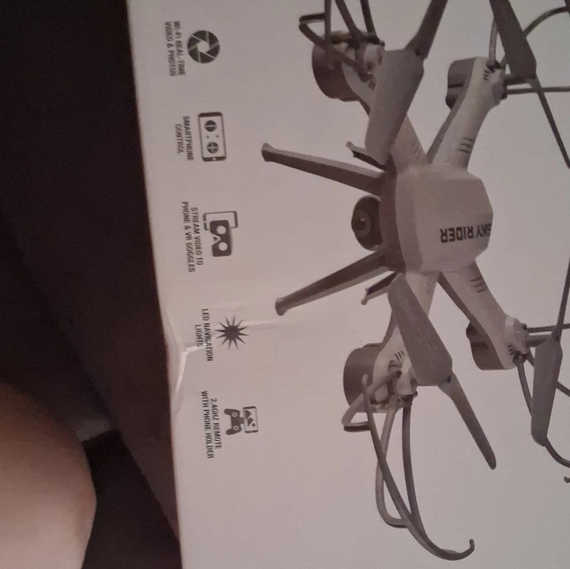 White quadcopter drone with camera and four propellers