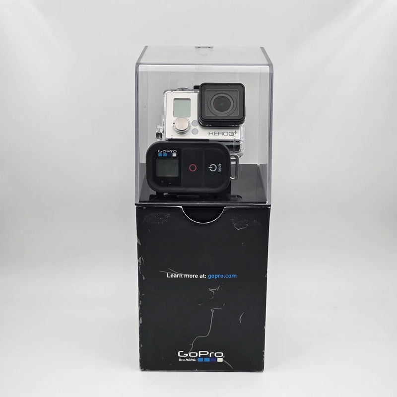 Silver waterproof action camera in open box, with front camera unit and mount