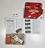 Red Bluetooth remote control battery with white cable and instruction documents