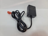 Battery charger power adapter with black cable and orange plug